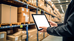 Worker with tablet in shipping warehouse. Product distribution and logistics