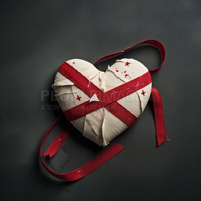 Heart wrapped in red ribbon. Heal broken heart concept.