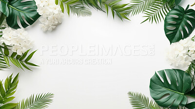 A frame of tropical leaves around a white empty space. Copy space concept.