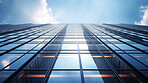 Reflective business office buildings. Low angle photography of glass building