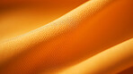 Close-up of folded, yellow texture fabric cloth textile background.