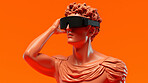 Sculpture or statue of David wearing a VR headset on an orange background