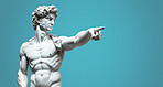 Sculpture or statue of David pointing and looking on a blue background