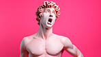 Sculpture or statue of David with shocked or surprised expression on pink background