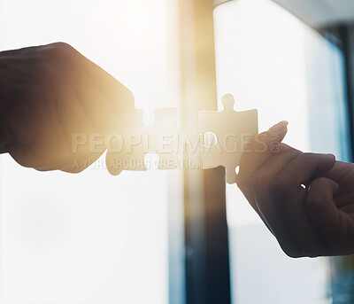 Buy stock photo Closeup shot of two unrecognisable people putting two puzzle pieces together