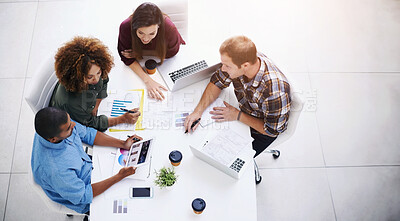 Buy stock photo High angle shot of a team of designers having a meeting in an office