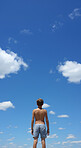 Low angle vertical shot. Child looking at blue-sky. Freedom concept.