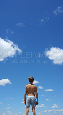 Low angle vertical shot. Child looking at blue-sky. Freedom concept.