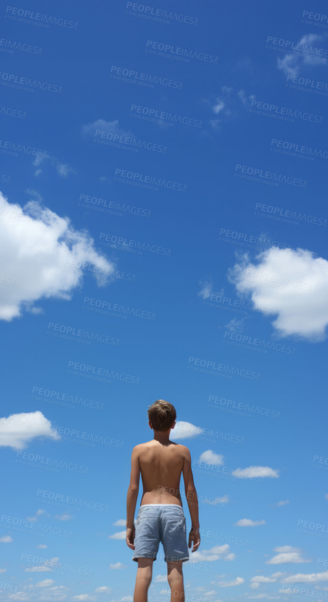 Buy stock photo Low angle vertical shot. Child looking at blue-sky. Freedom concept.