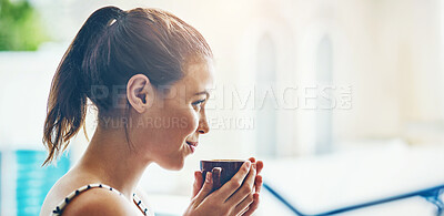 Buy stock photo Shot of a relaxed young woman having a cup of coffee at a cafe