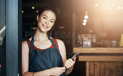 Buy stock photo Portrait of a confident young woman standing in the doorway of a coffee shop