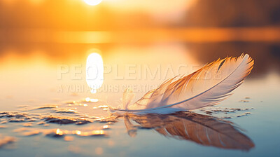 Closeup white feather floating on water. Peace, hope, and faith concept