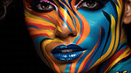 Closeup colorful makeup or face paint and feathers on model. Creative art background