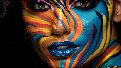 Closeup colorful makeup or face paint and feathers on model. Creative art background