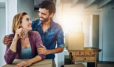Buy stock photo Shot of a couple moving into their new home