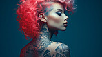 Attractive tattooed model against backdrop. Alternative beauty concept.