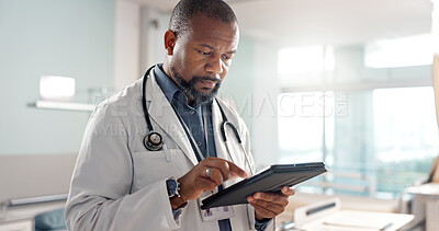 Healthcare, typing and a black man or doctor with a tablet for a medical app or communication. Mature, reading email and an African surgeon with technology for results, information or surgery advice