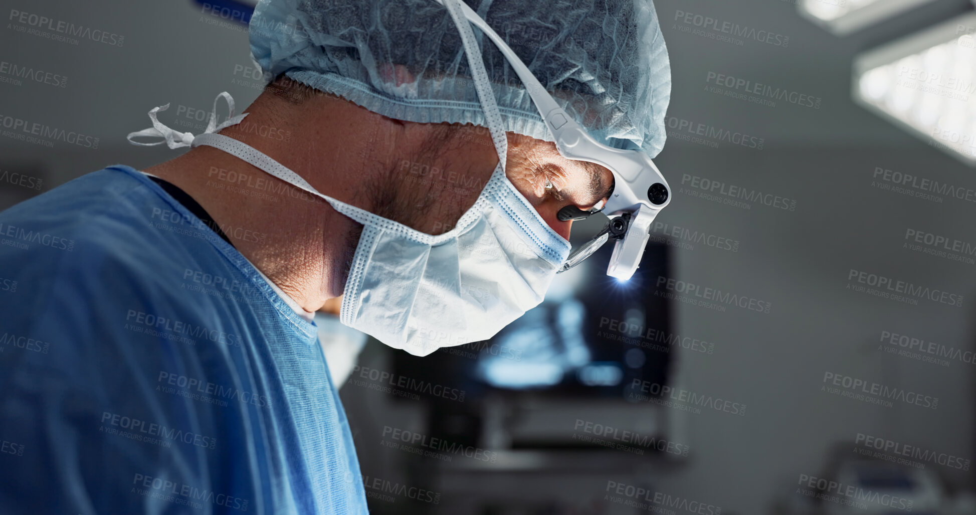 Buy stock photo Surgery, hospital and doctor with face mask for operation, medical emergency and service in theater. Healthcare, procedure and closeup of surgeon with light for patient injury, wellness and accident