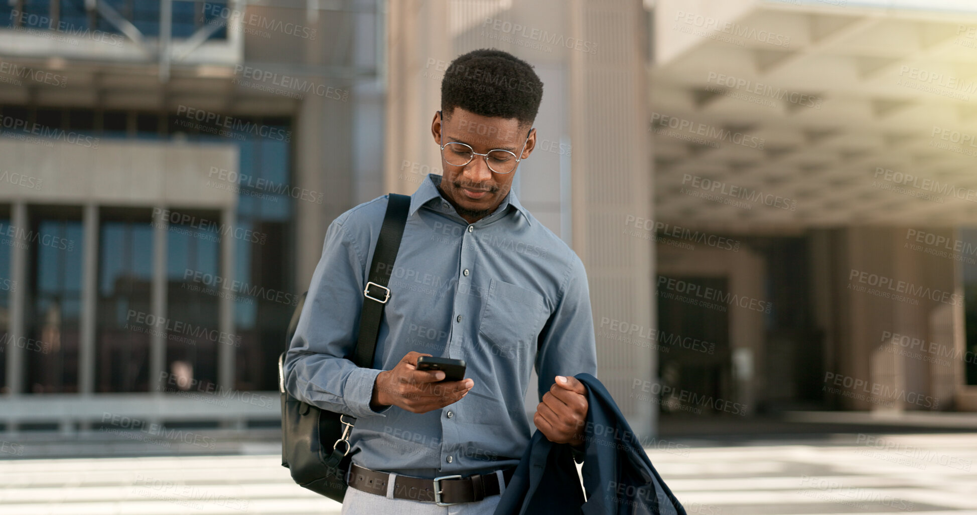 Buy stock photo Man, walking and texting from work, corporate clothes and wondering in city, buildings and outside. Professional, employee and leaving on social media, communicating and thinking of day, text or post