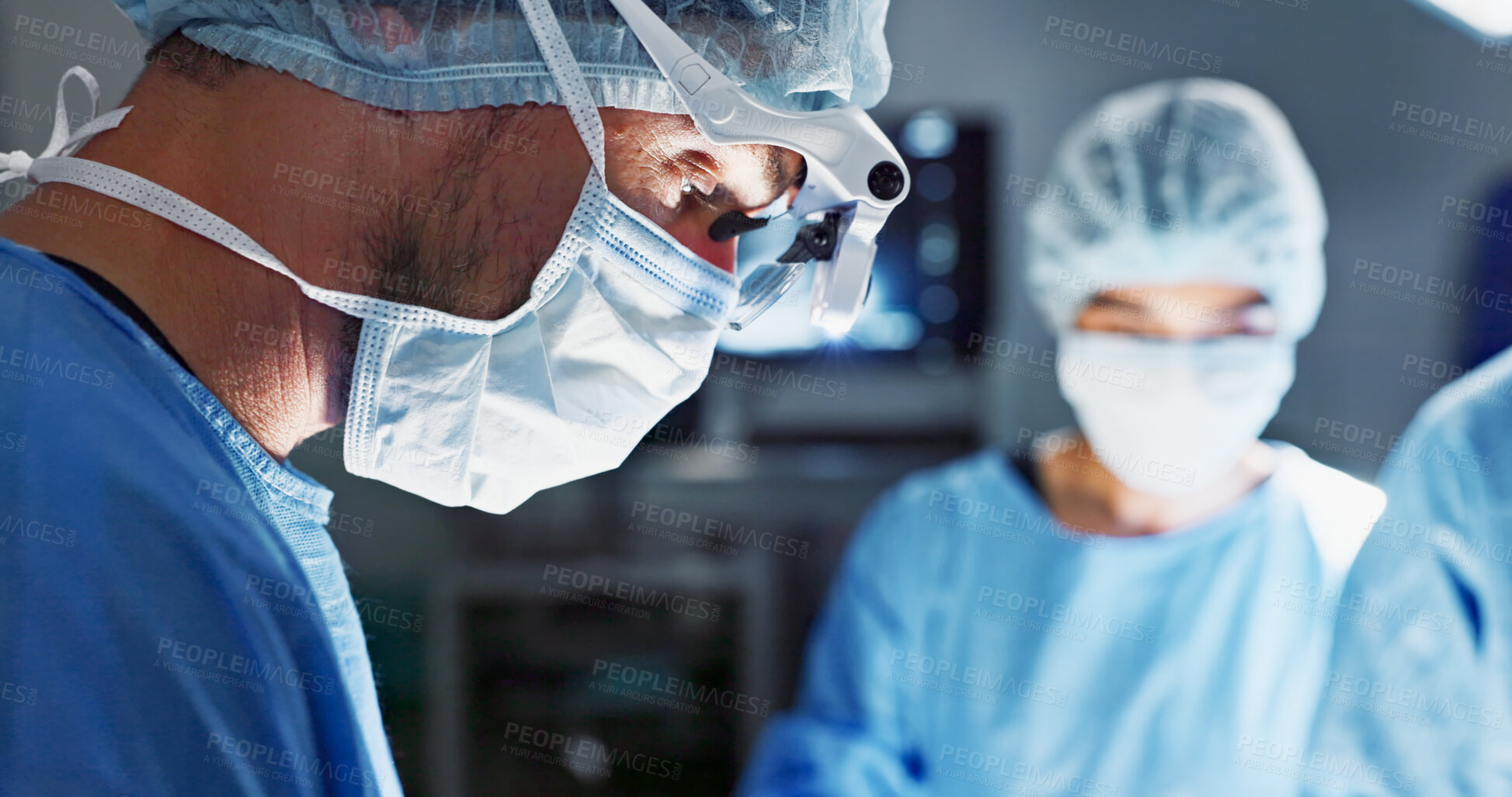 Buy stock photo Surgery, hospital and doctor with face mask for operation, medical emergency and service in theater. Healthcare, procedure and closeup of surgeon with light for patient injury, wellness and accident