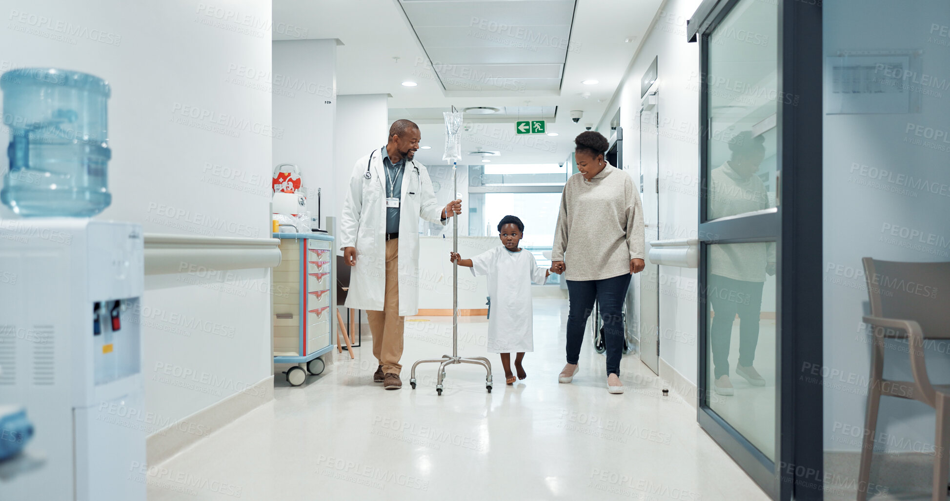 Buy stock photo Medical, pediatrician and a doctor walking with a black family in a hospital corridor for diagnosis. Healthcare, communication and consulting with a medicine professional talking to a boy patient