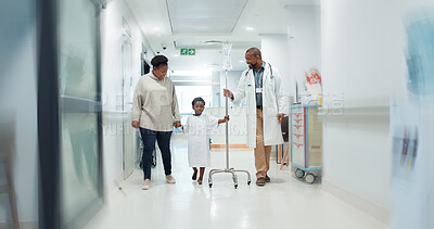 Medical, pediatrician and a doctor walking with a black family in a hospital corridor for diagnosis. Healthcare, communication and consulting with a medicine professional talking to a boy patient