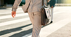 Businessman, walk and city street closeup or morning work commute, briefcase or professional. Male person, legs or corporate employee fashion or suit leather bag, public travel for career on sidewalk