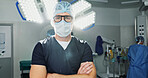 Surgeon, doctor and man in portrait with arms crossed, healthcare and confidence in operation theater for medical procedure. Surgery, health professional and help in hospital, expert with face mask