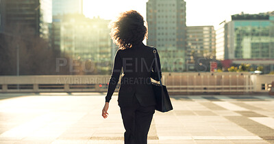 Buy stock photo Urban, back and professional person walking on outdoor journey, morning commute and executive on way to job career. City architecture buildings, sunset or pedestrian on travel to work