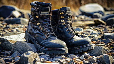Combat boots in rocky area. Used military gear for soldier safety