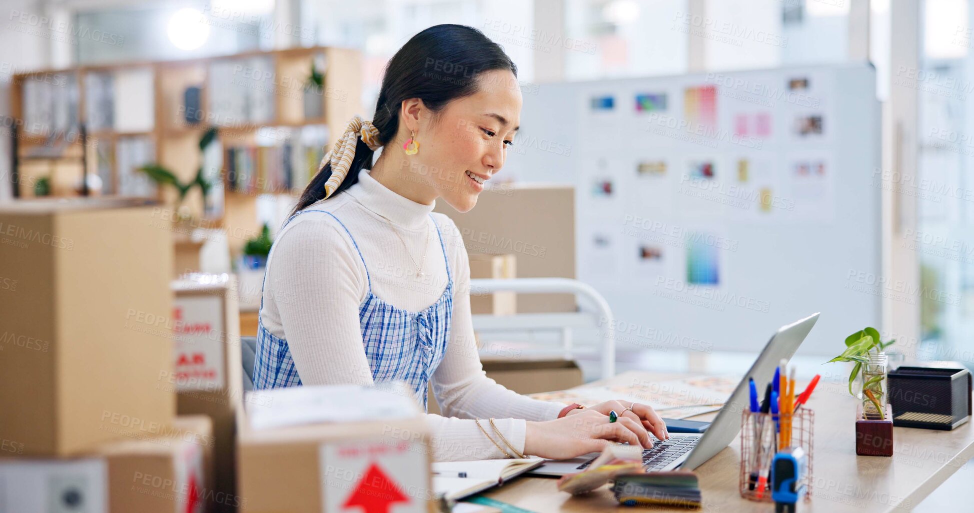 Buy stock photo Ecommerce, Asian woman at laptop with typing and smile for sales report and work at fashion startup. Online shopping, boxes and small business owner with happiness, computer and website shop at desk.