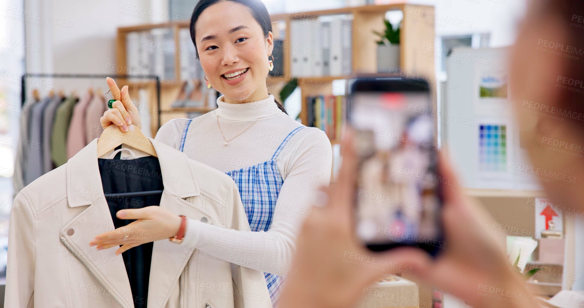 Buy stock photo Fashion influencer, phone and Asian woman live streaming clothes, leather jacket design or shooting vlog commercial. Cellphone recording, social media app and Japanese person explain retail product