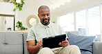 Technology, mature man with tablet and in living room of his home happy for social media. Online communication or networking, connectivity or leisure and black male person on couch with smile