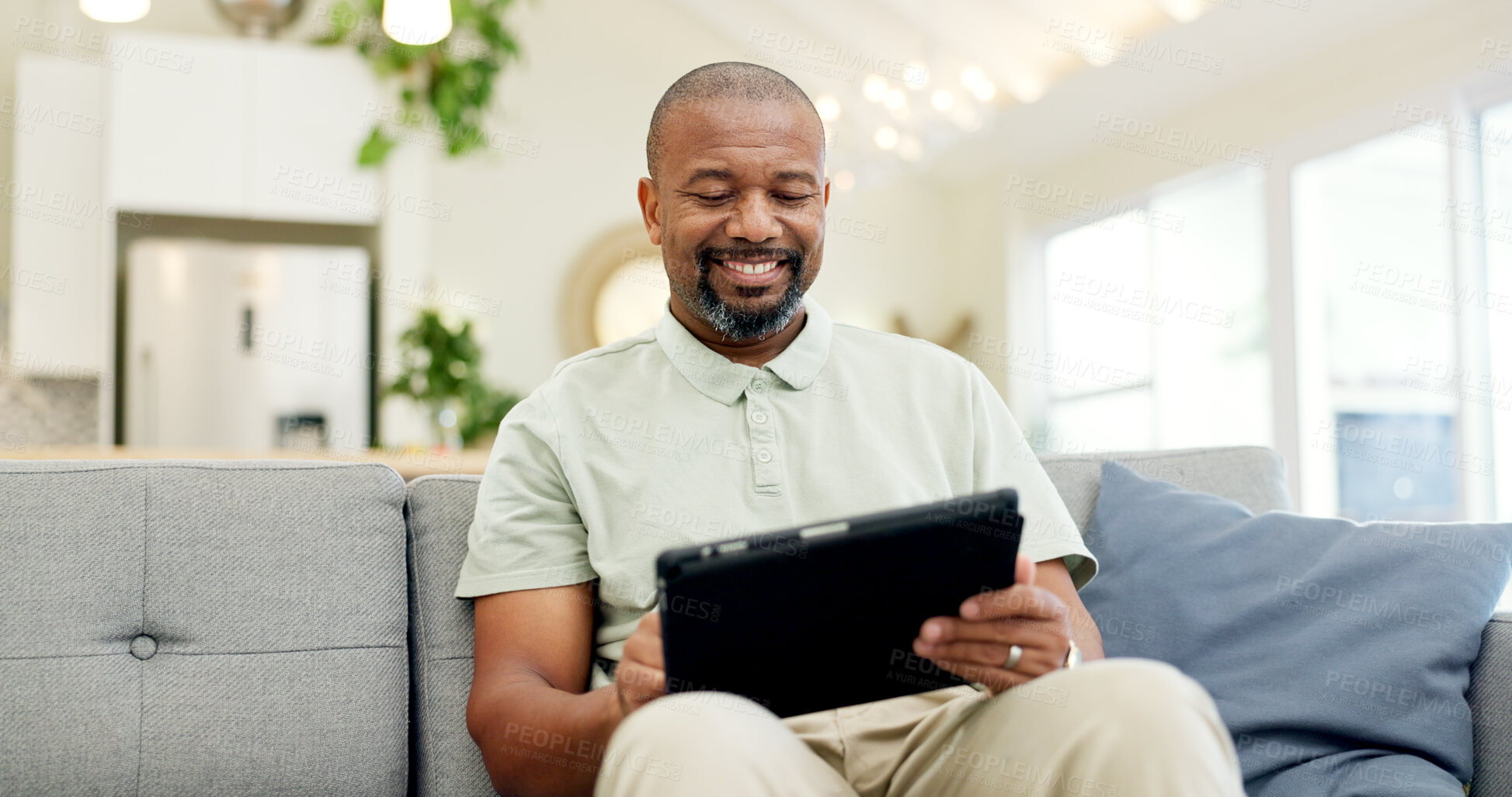 Buy stock photo Technology, mature man with tablet and in living room of his home happy for social media. Online communication or networking, connectivity or leisure and black male person on couch with smile