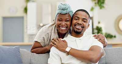 Black couple, smile and portrait in a house feeling happy in a living room on a couch. Face, African people and hug with love and support in a home on a lounge sofa with a woman and man together