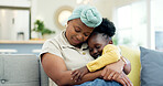 Mother hug sleeping child on couch for love, care or holding for comfort in lounge at home. Black woman, happy mom and kissing girl kid on lap for nap, rest or support to relax on sofa in living room