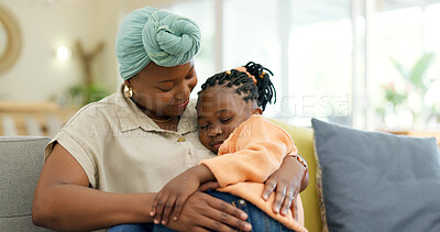 Mother hug sleeping child on couch for love, care or holding for comfort in lounge at home. Black woman, happy mom and kissing girl kid on lap for nap, rest or support to relax on sofa in living room