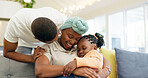 Black family, relax and parents hug child on sofa at home for bonding, quality time and happiness. Love, lounge and happy mother, father and girl on couch embrace together for care in living room