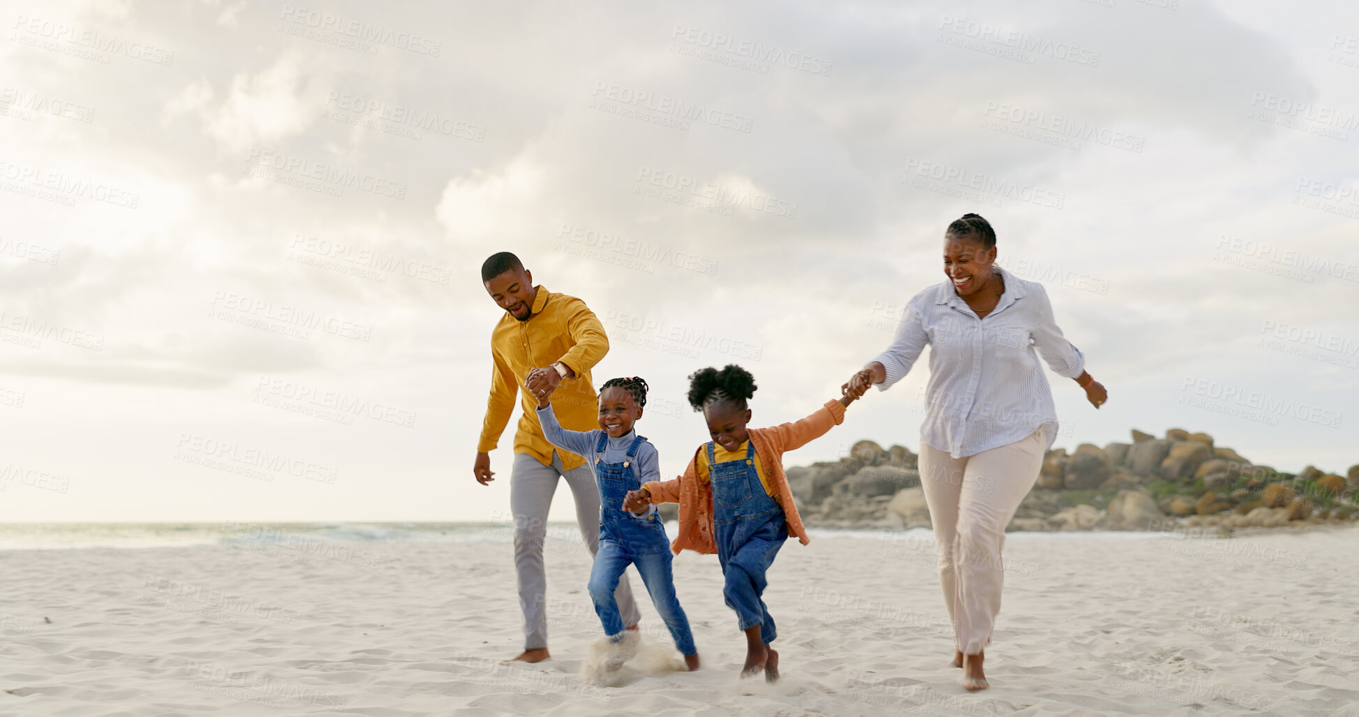 Buy stock photo Happy, travel and holding hands with black family at beach for summer, vacation and relax. Holiday, support and love with parents and children walking on coastline for care, trust and freedom