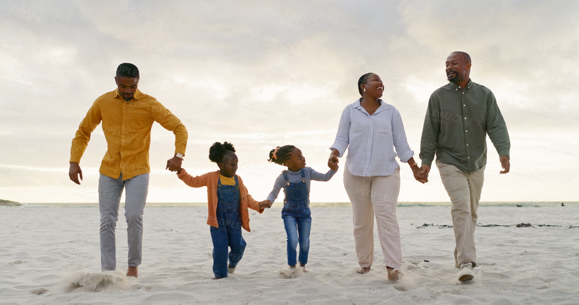 Buy stock photo Love, travel and holding hands with black family at beach for summer, vacation and relax. Holiday, support and happy with parents and children walking on coastline for care, trust and freedom