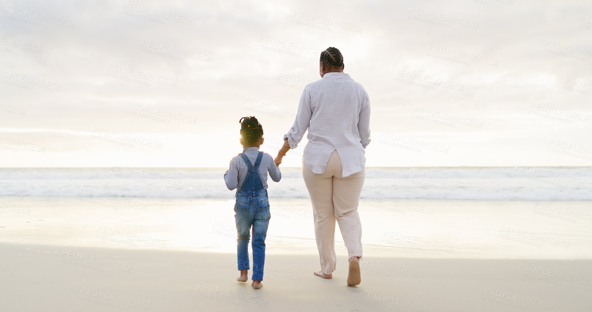 Buy stock photo Black family, mother and daughter holding hands, beach and bonding with love and care, back view and walk outdoor. Sea, freedom and travel, woman and girl on holiday with trust and support in nature