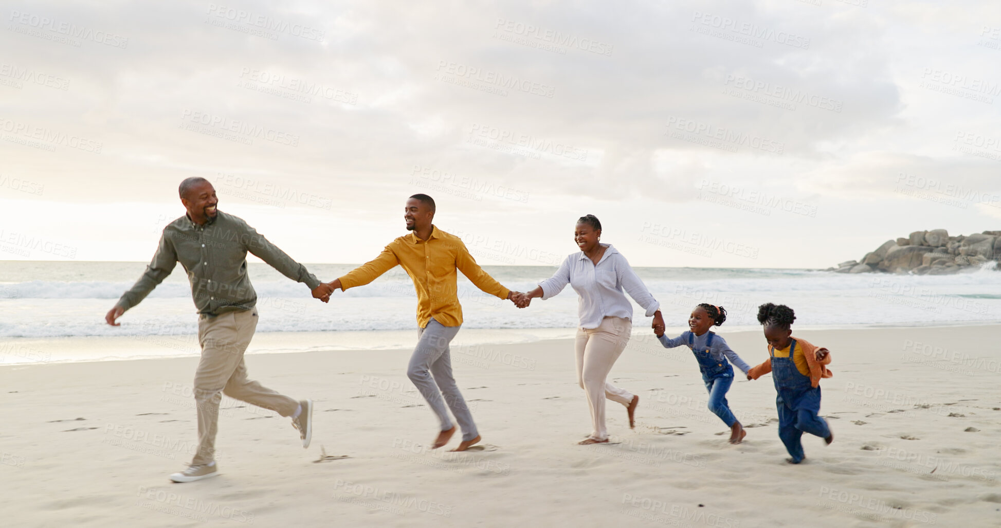 Buy stock photo Happy, black family and holding hands or running at the beach for holiday, care and bonding. Laughing, support and grandparents, father and children with affection and exercise by the sea with love