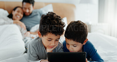 Brothers, children and tablet with parents on bed for game, movies or relax together with mom, dad and laugh. Happy family, boy kids and digital touchscreen for app, learning or development in home