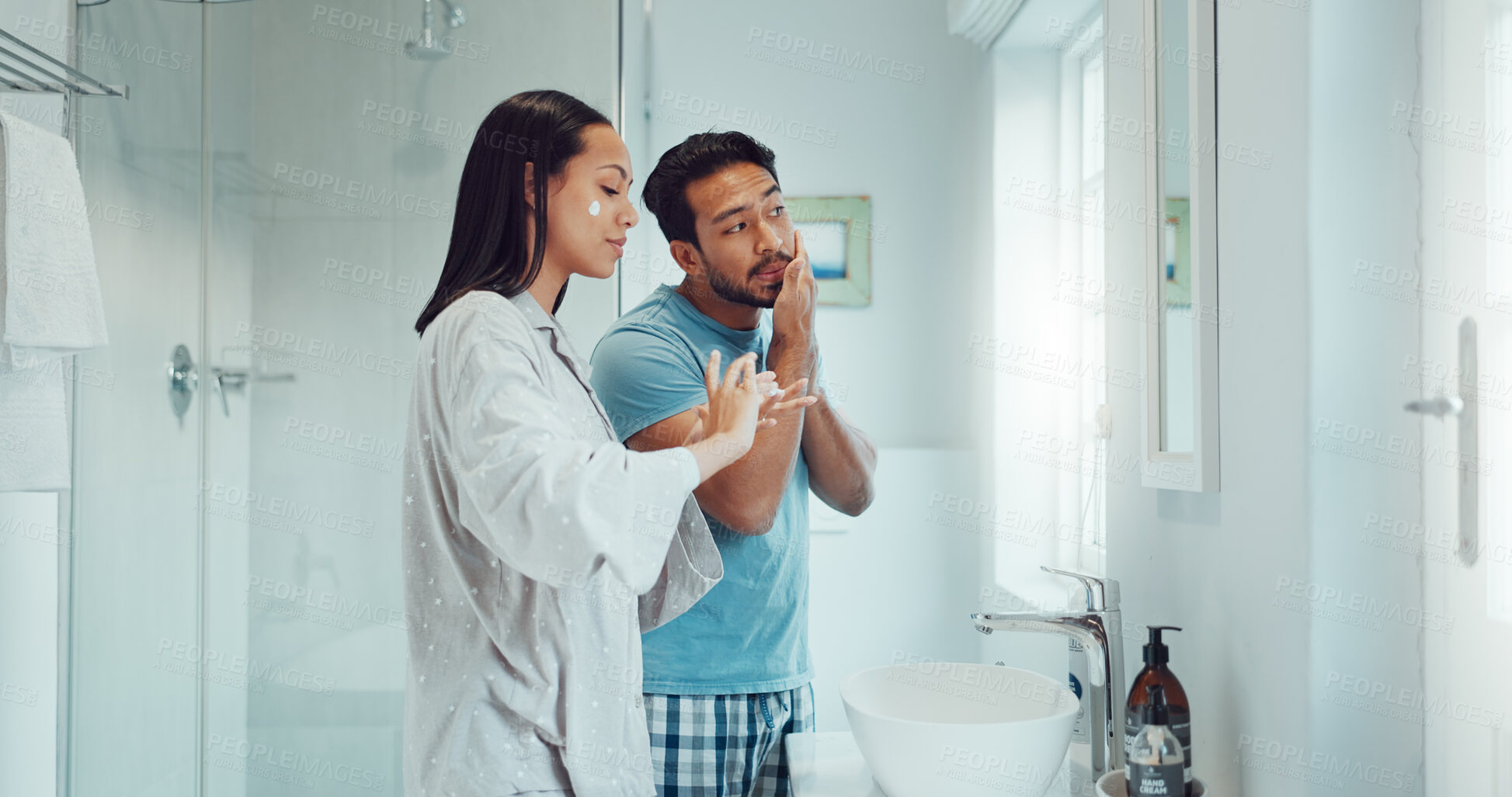 Buy stock photo Couple, bathroom and cleaning face with cream, skincare and comic joke with laughing, serum or product. Man, woman and funny with facial oil moisturizer for beauty, wellness or self care in apartment