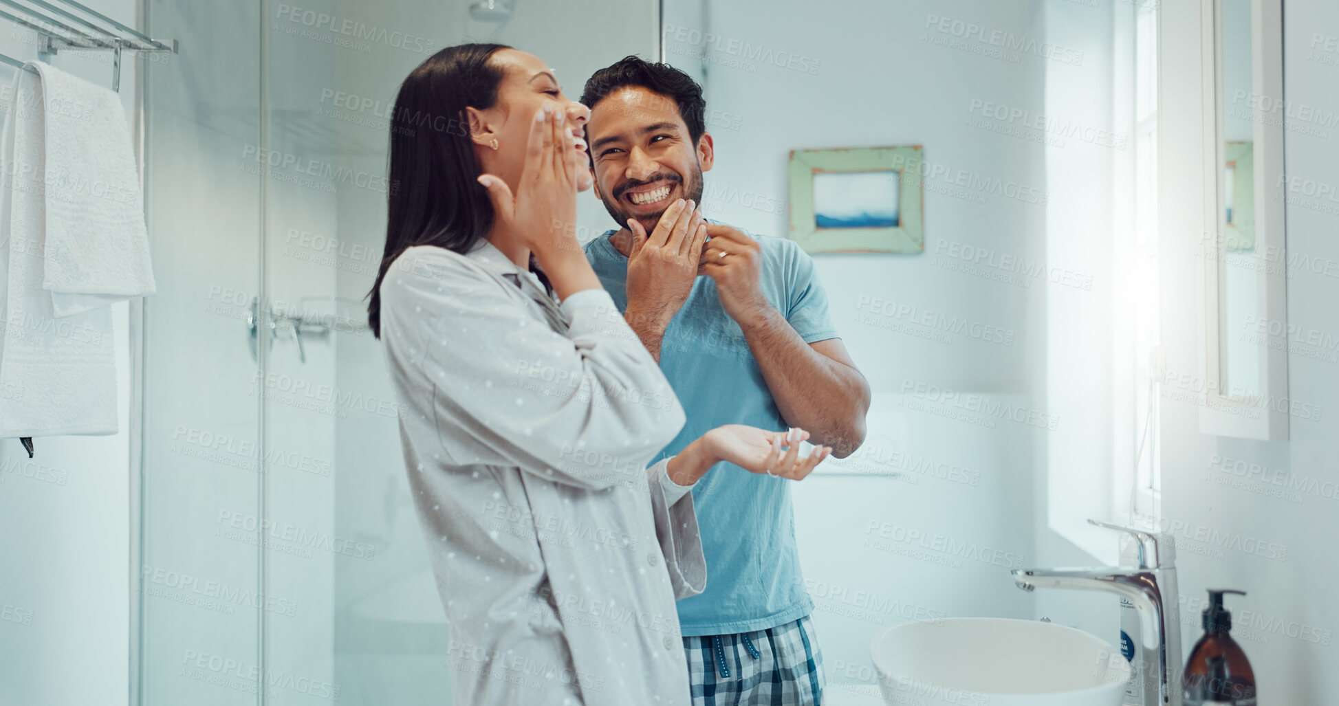 Buy stock photo Couple, bathroom and cleaning face for skincare, routine and comic joke with cream, serum and product. Man, woman and funny with facial oil moisturiser for health, wellness and self care in apartment