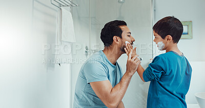 Shaving, bathroom and father teaching child about grooming, hygiene and facial routine. Happy, help and a young dad showing a boy kid cream or soap for hair removal together in a house in the morning