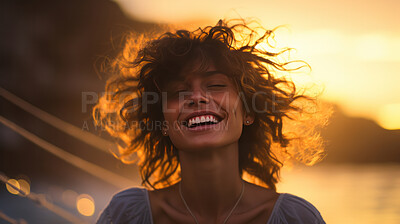 Woman laughing on beach. Happy young woman at sunset. Golden hour concept.