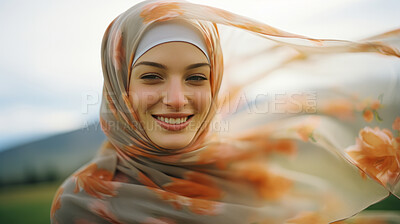 Portrait of happy arab woman in field of grass. Smiling and enjoying moment.