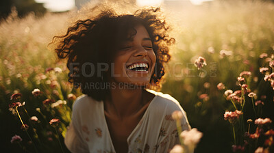 Happy young woman. Laughing in field of flowers at sunset.