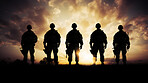 Silhouette of armed soldiers or marines in a row. Sunset.
War concept.